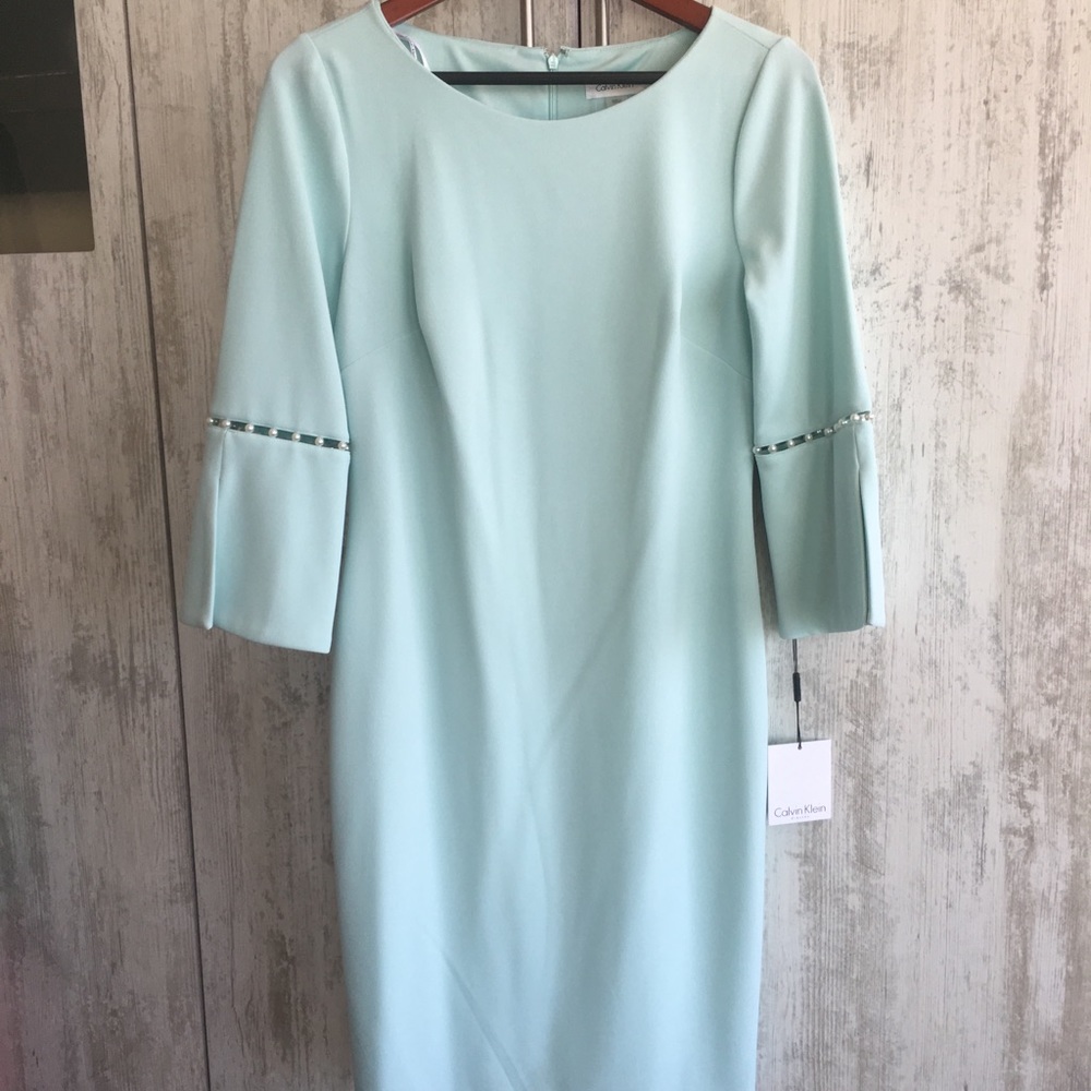Calvin Klein with faux pearls at sleeves